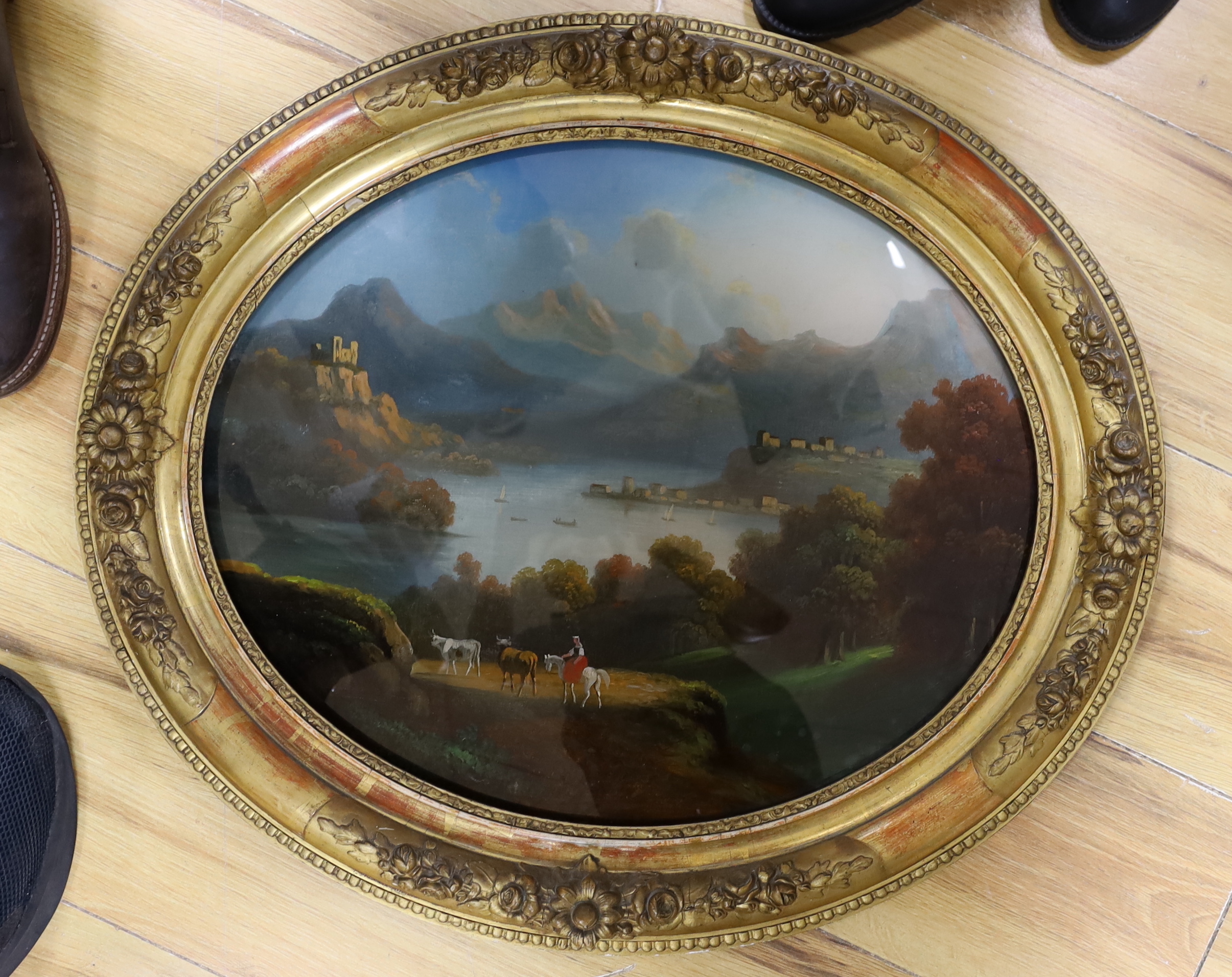 19th century Italian School, reverse glass painting, mountainous lakeside landscape, oval, 44 x 36cm